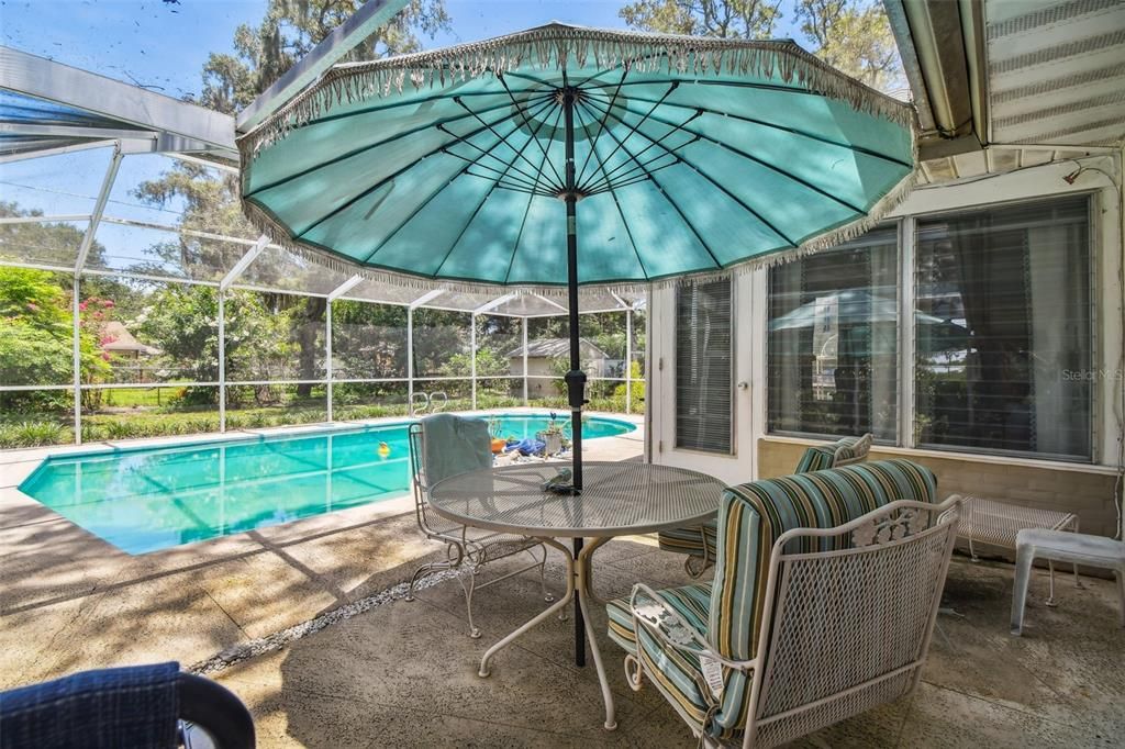 Screened lanai overlooking pool and with access through the Florida Room