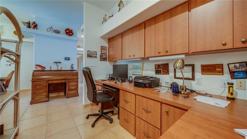 Office with built in desk and cabinetry