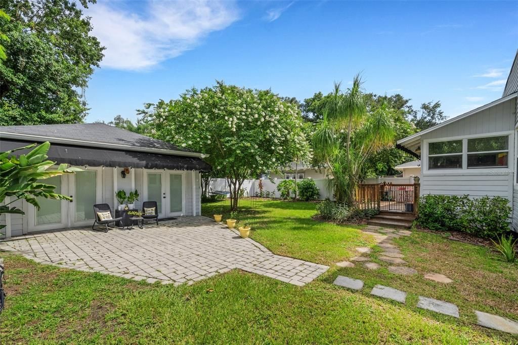 Walk up the Paved entry to two sets of French Doors entering the Guest House.