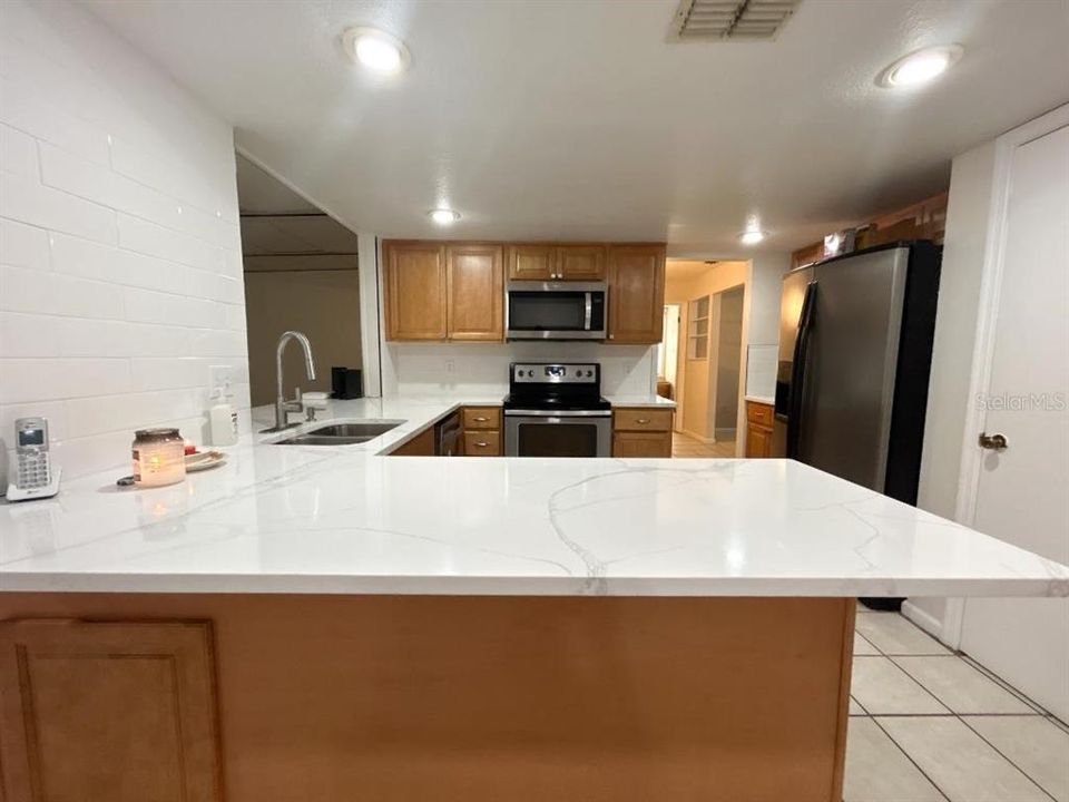 Updated Kitchen with quartz and tile backsplash