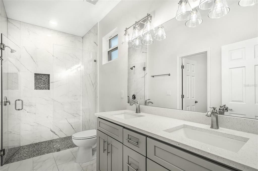 Double sinks in Master bathroom w/ seamless glass shower