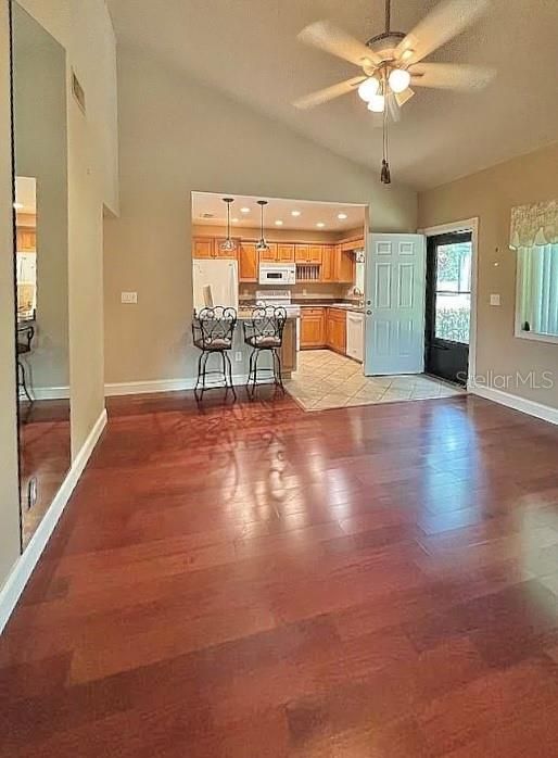 Living room with cathedral ceilings showing front door