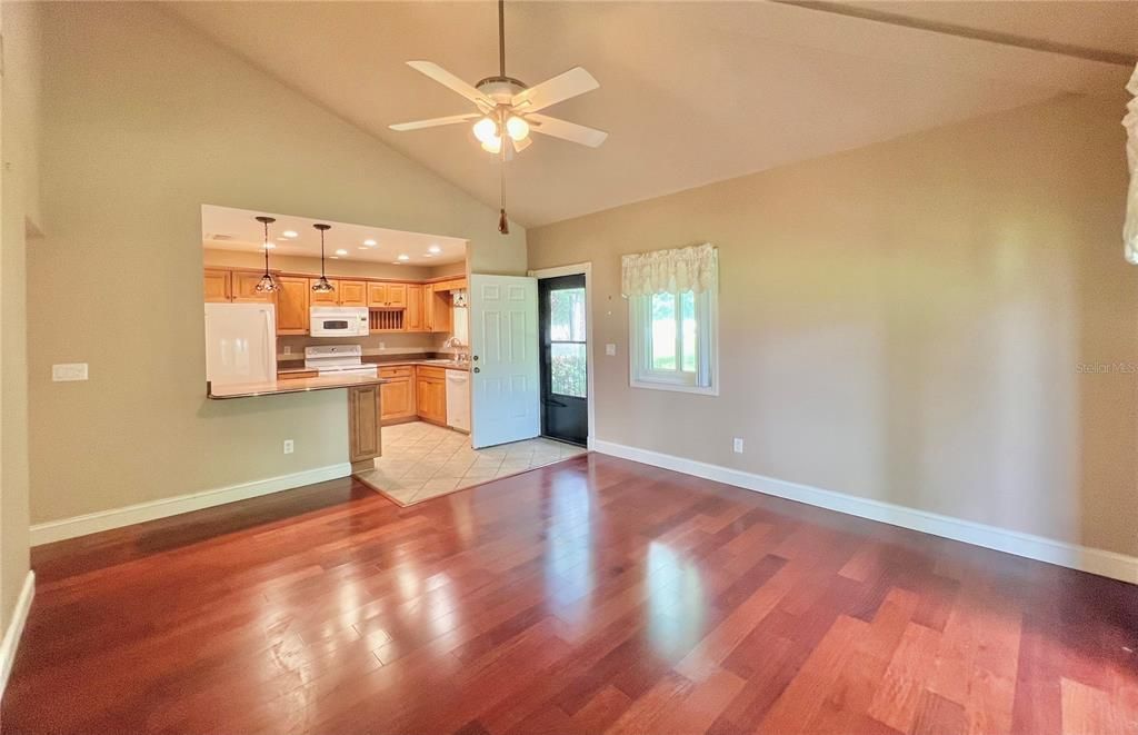 Living room with cathedral ceilings showing front door