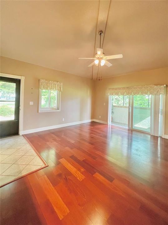 Living room with front door and sliders to the rear pario