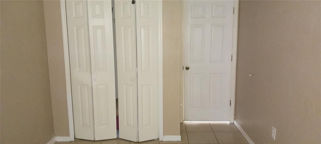 3rd bedroom door and closet