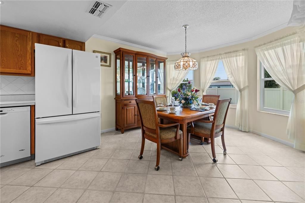 THE BREAKFAST AREA HAS NATURAL LIGHT THROUGH ITS HURRICANE-RATED WINDOWS, COMBINING BRIGHTNESS WITH ADDED SECURITY.