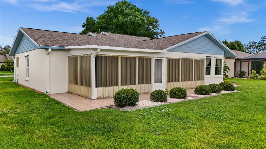 THE BACK PATIO AREA IS TILED. CURRENTLY THE HOME HAS THE ACRYLIC HURRICANE SHUTTERS IN PLACE, WHICH CAN BE EASILY REMOVED. THERE ARE PANELS FOR THE BACK DOOR.