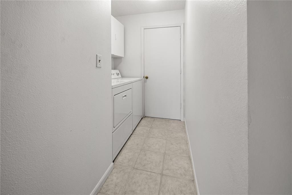 INDOOR LAUNDRY ROOM HAS PLENTY OF STORAGE AND EASY ACCESS TO THE 2 CAR GARAGE.