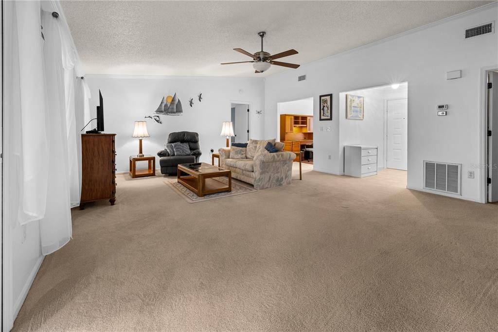 VIEW FROM THE KITCHEN TOWARDS THE GREAT ROOM, DEN AND PRIMARY BEDROOM.