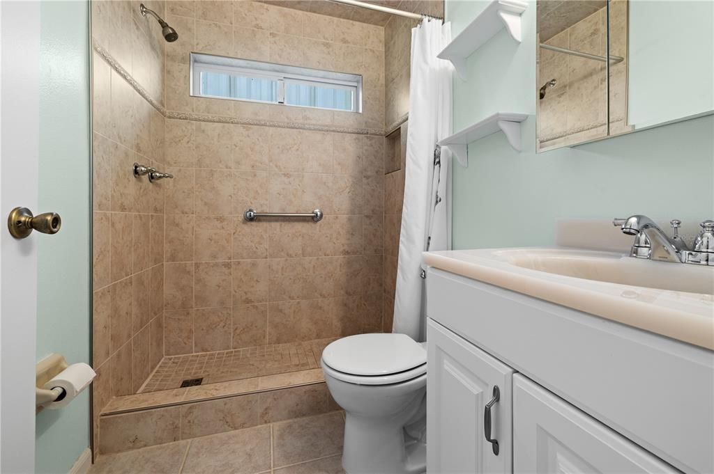 THE MAIN BATHROOM  HAS BEEN UPDATED WITH NEUTRAL COLOR CERAMIC TILE SHOWER SURROUND, FLOOR AND VANITY.