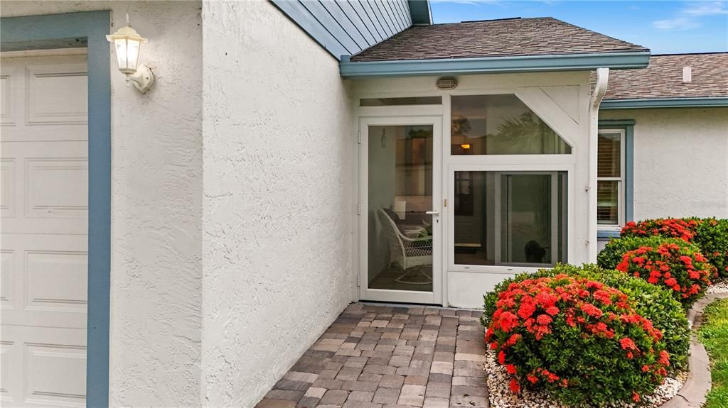 THE FRONT LANAI HAS A HURRICANE RATED STRUCTURE WITH WINDOWS, SCREENS AND TILE FLOOR.