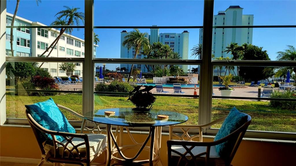 Tropical pool views from living room. Colored LED lights in pool at night.