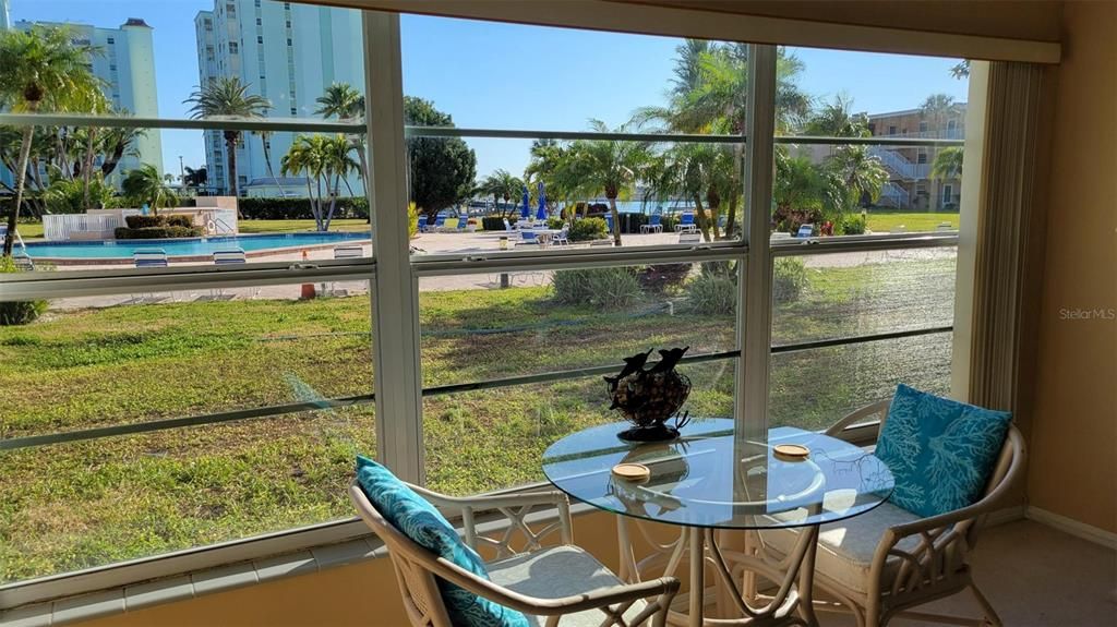 Tropical Bay & pool views form living room. Colored LED lights in pool at night.