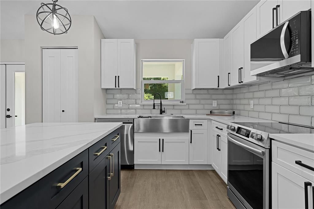 Beautiful kitchen with subway tile backsplash and stainless steel farmhouse sink