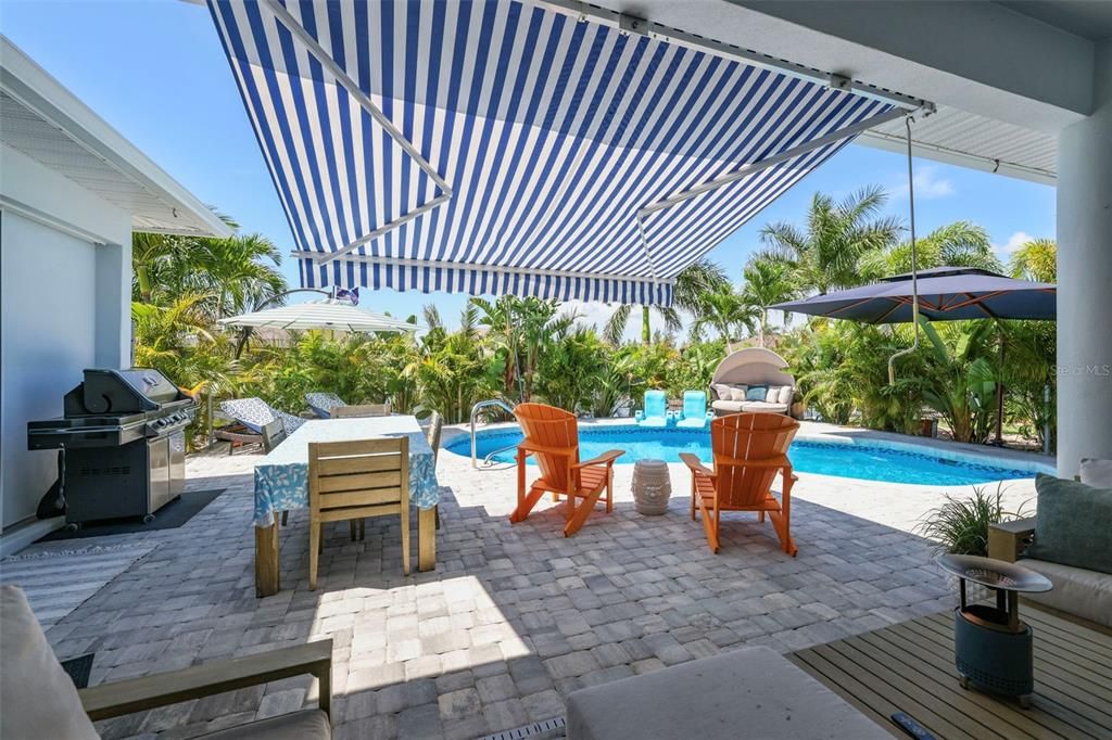 Another view of the oversized heated pool with steps down and hand rail.