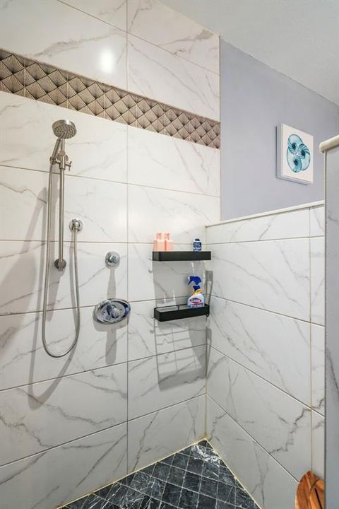 The walk-in shower features quality tile and thoughtful design.