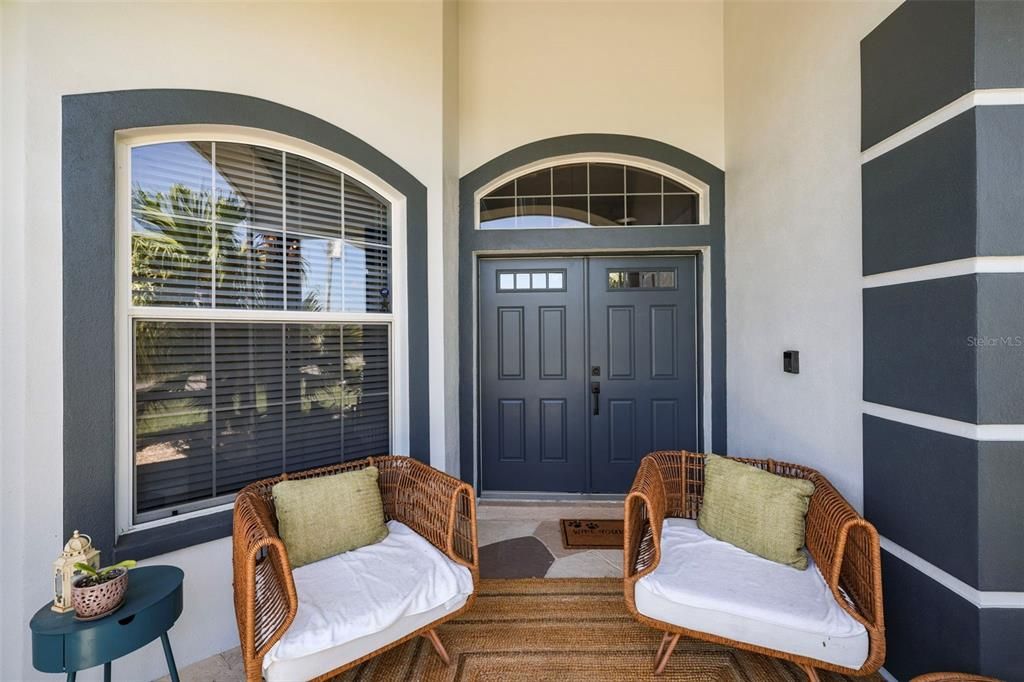 Impressive front entry is screened-in and provides space for a quiet sitting area.