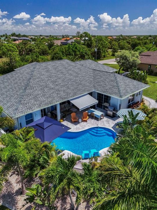 Ariel view of the impeccably designed pool area with mature landscaping for privacy.