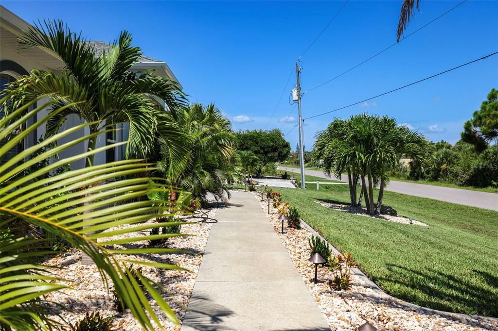 Walkways and lush landscaping surround the home