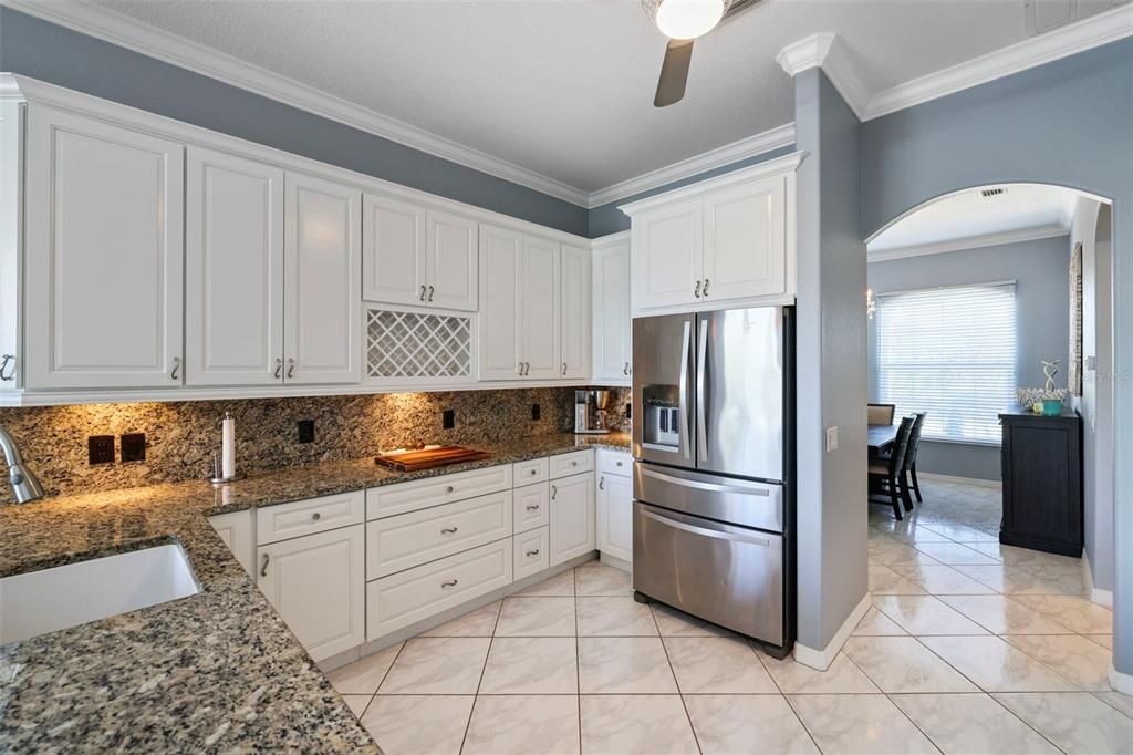 The kitchen features plenty of storage, granite counters-tops and backsplash.