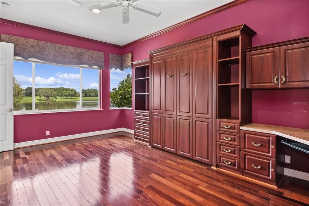 Bedroom #2 at the rear of the house off of the family room has a walk in closet, built in cabinets and a murphy bed