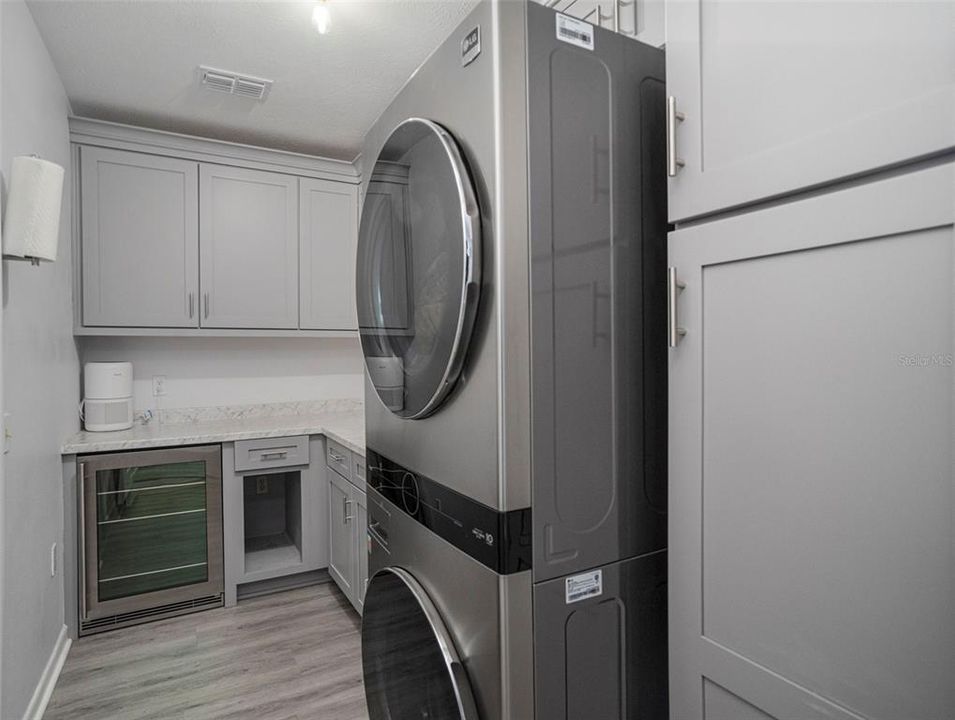 Laundry Room with Cabinets and Undermount Refrigerator