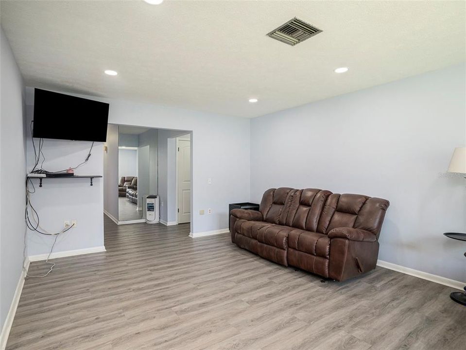 Living Room receives natural light and has new recessed lighting