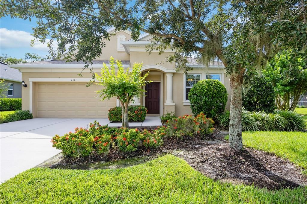 Lush tropical landscaping surrounds home truly encapsulating that Florida tropical feel