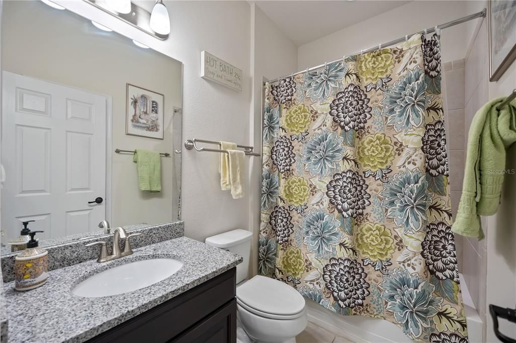 Second bathroom with shower and tub combination is shared between second and third bedrooms