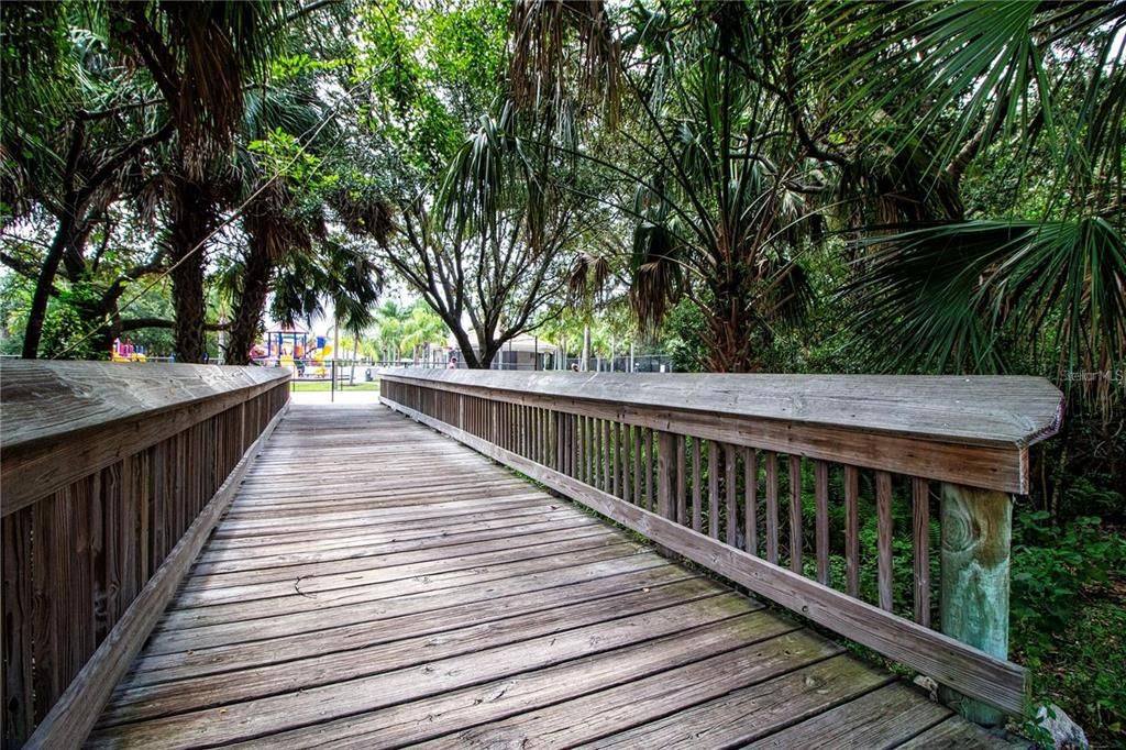 Bridge walkway leading to the waterslide, fitness center, basketball, tennis and pickleball courts, connecting East to West communities.