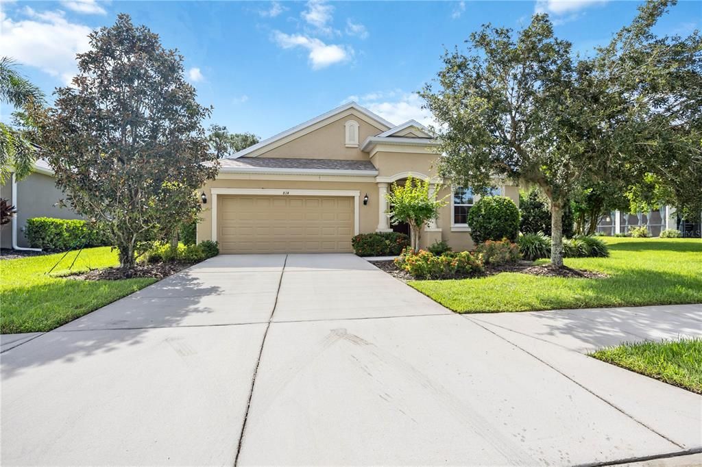 Concrete driveway leads to spacious two car garage