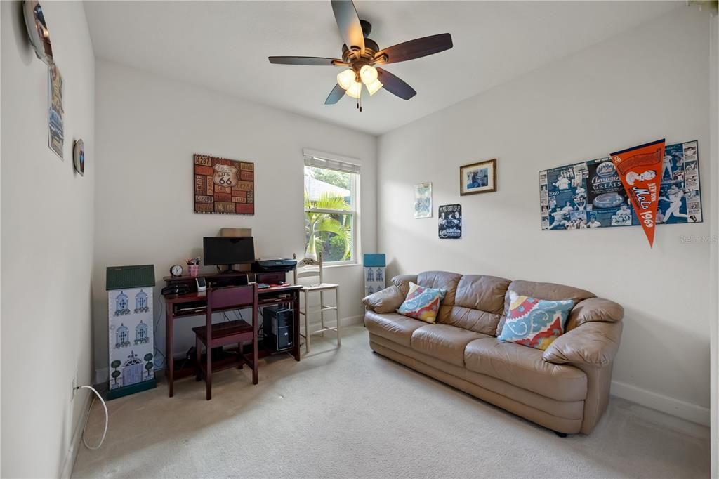 Third bedroom with ceiling fan and carpet flooring along with a spacious storage closet.