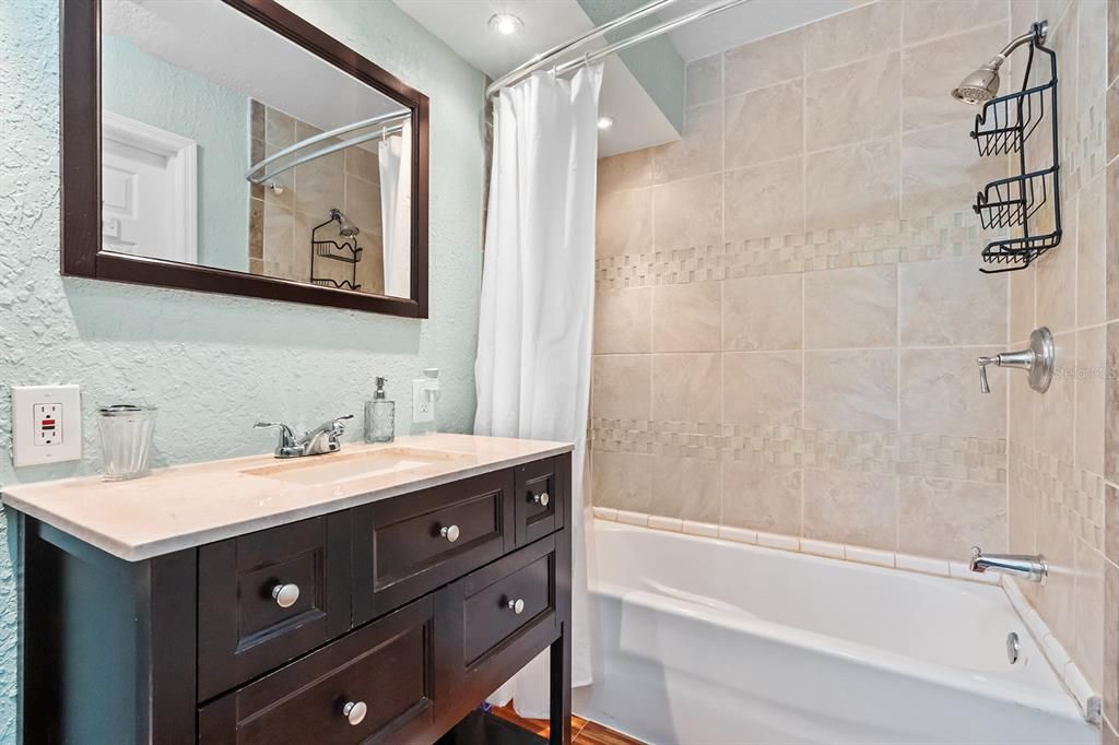 Primary Bathroom with decorative tile shower.