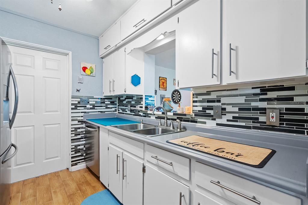 Window over kitchen sink overlooks the enclosed Florida Room and huge backyard.