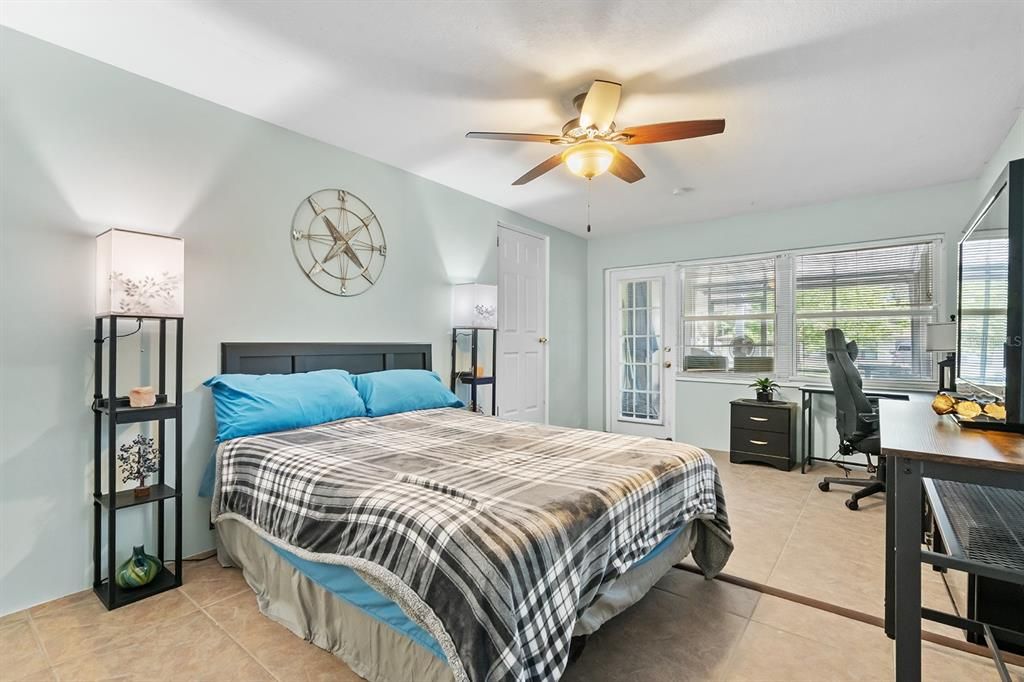 Third Bedroom with Walk-in Closet and entrance to front screened-in patio as well as access to the kitchen and laundry room.