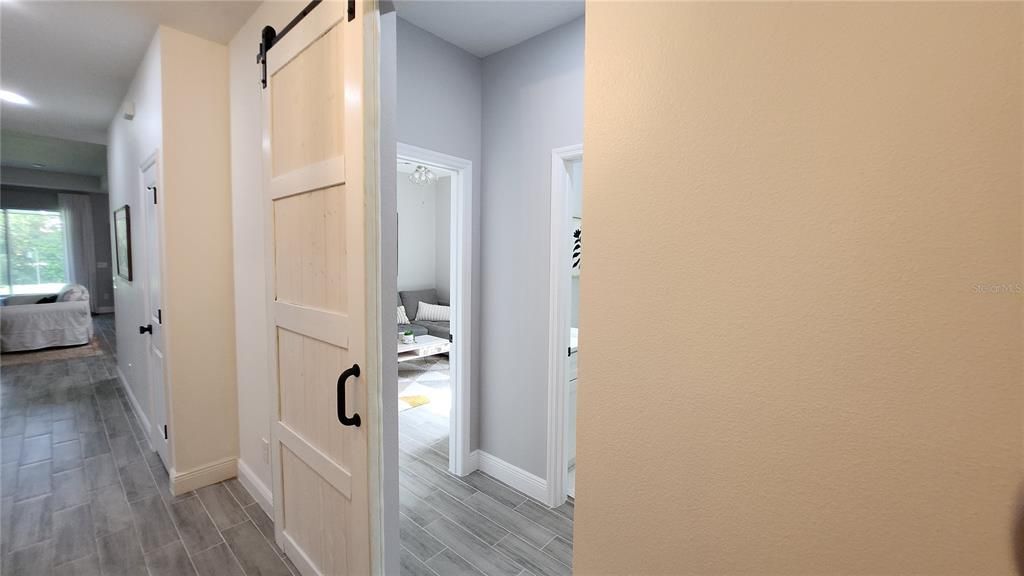 The Barn Door Affords Privacy to Bedroom 2 & 3  and private bath