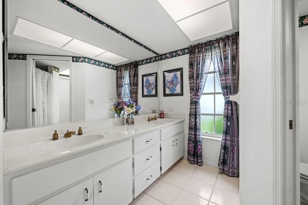 Main bathroom with shower and dual sinks