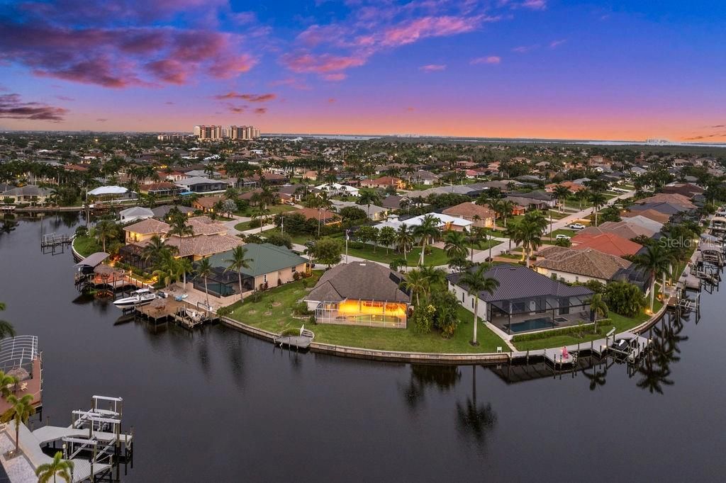 Aerial view in the evening of the back of the home