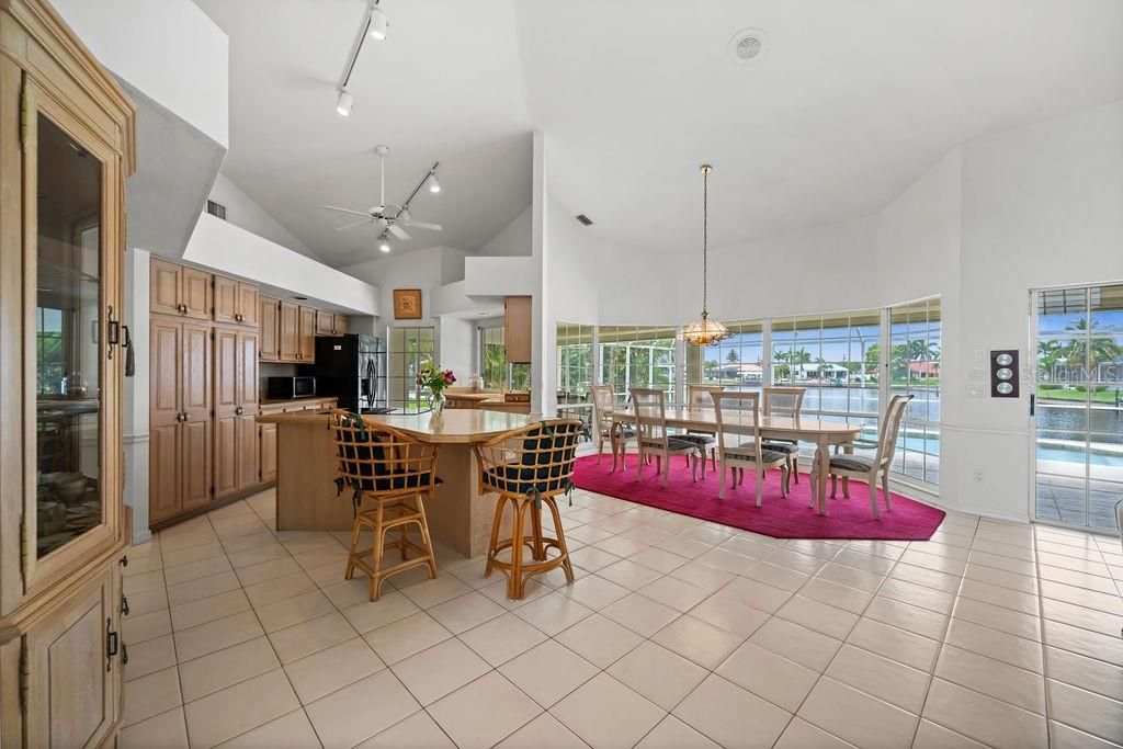 Kitchen, dining room and family room. Tall ceilings and wall to wall view of the pool and the canals.