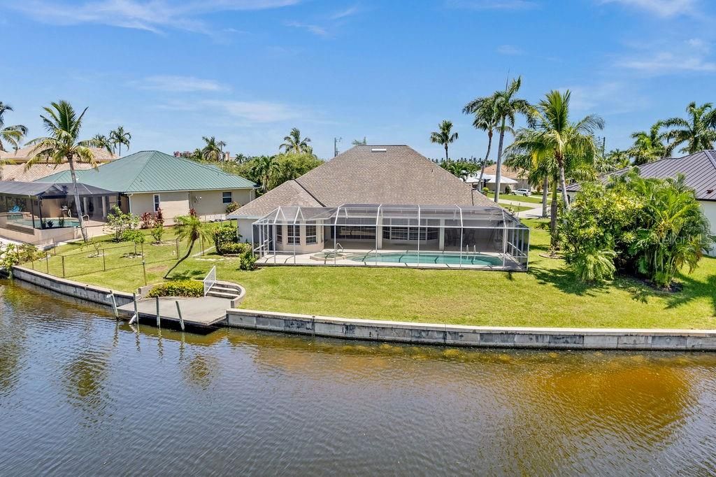 The back of the home with large side yard on the left. 141 Feet of Waterfront!