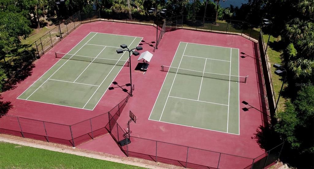 •Double asphalt tennis courts, lighted and fully fenced, with covered bench area