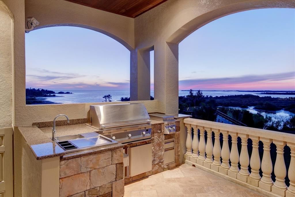 Outdoor Kitchen with cypress tongue and groove ceilings, surround sound, wet bar, granite, stainless bar, sink, ice bin, Twin Eagle gas grill, rotisserie, 2 gas burner stove, & Sherwin Williams Emerald rubberized paint to withstand salt air