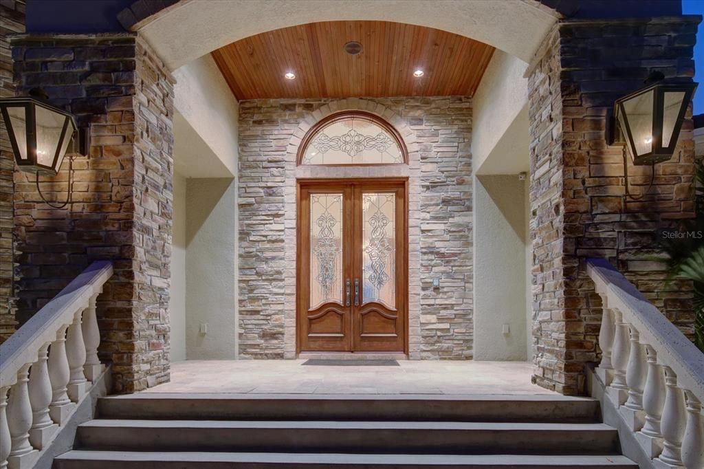 Double front doors, Brazilian Mahogany resists hot weather, with leaded glass, & hurricane engineered