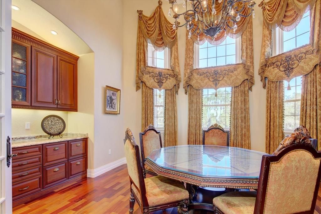 The library has a motorized chandelier, built in file cabinets, lighted upper cabinets