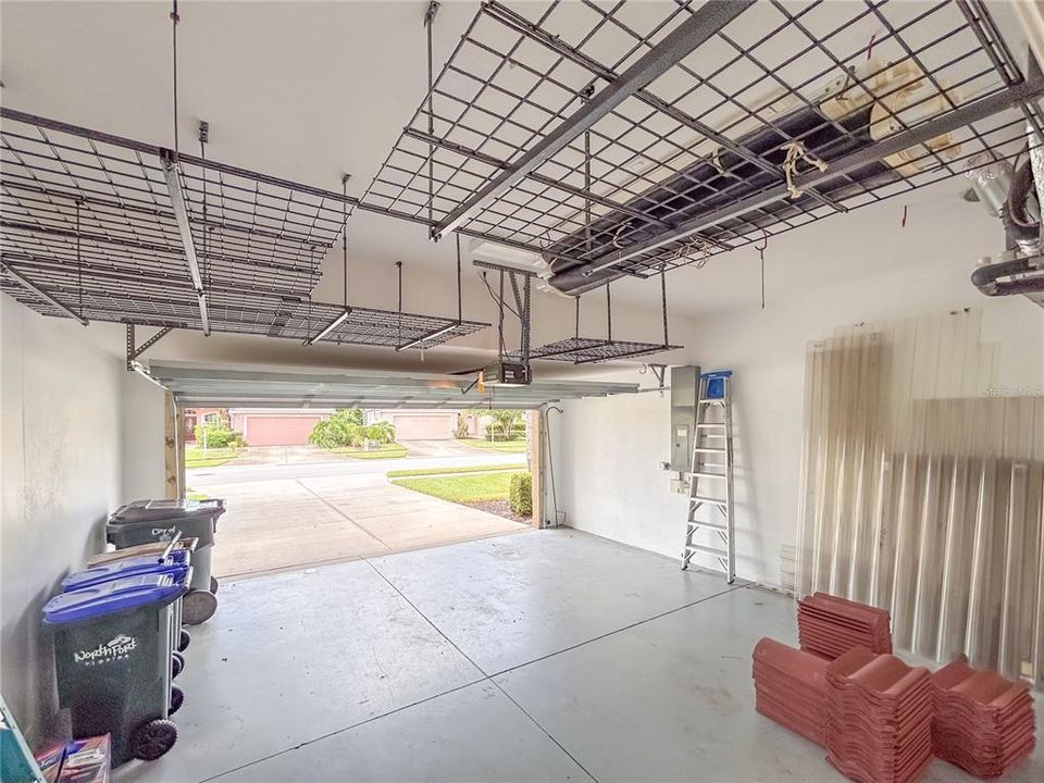 Garage with ceiling storage rack system