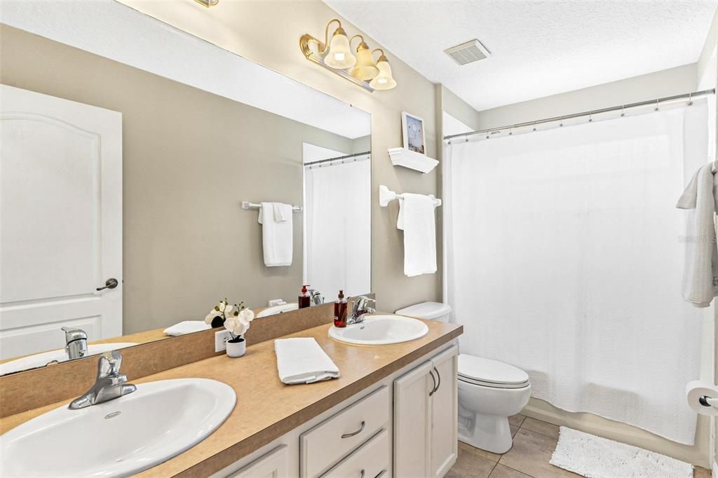 Guest Bathroom with Dual Sinks and Tub and Shower Combo