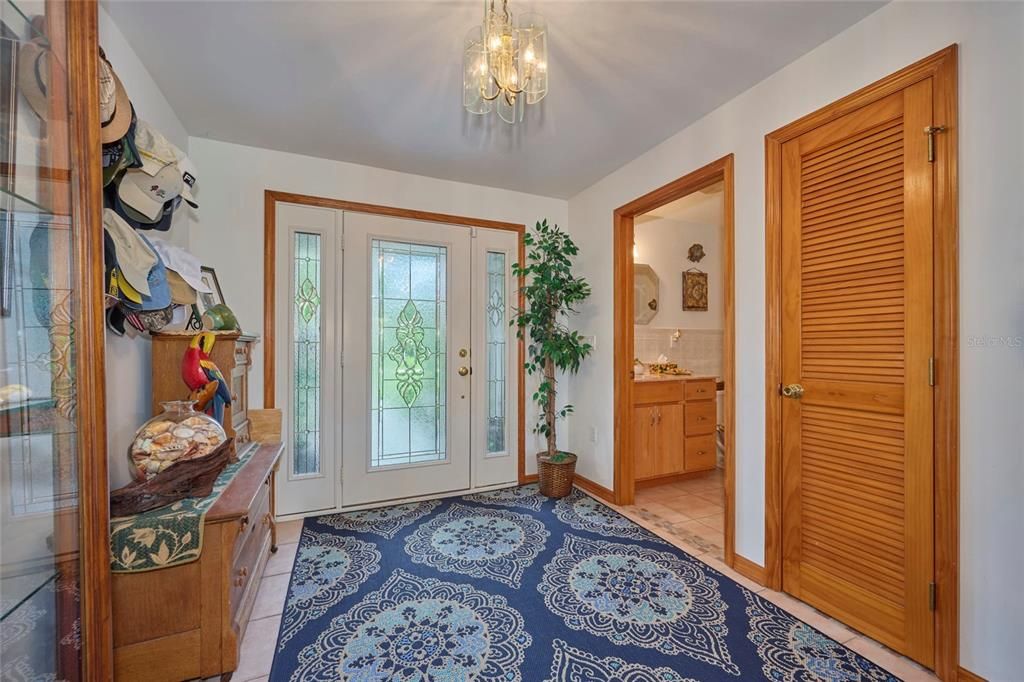 Big foyer entrance that has a half bath for guests