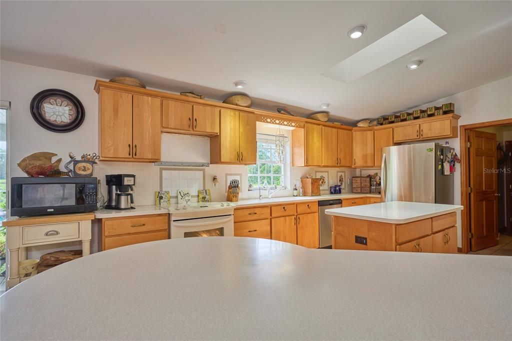 This kitchen is glorious!  Lots of counter space, cabinetry and a huge breakfast bar!  Since this picture was taken, the sellers have replaced the microwave.