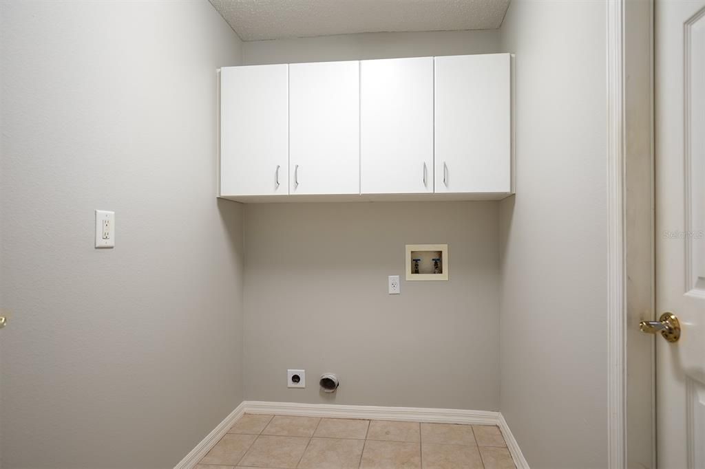 Inside laundry room with storage and plenty of space.