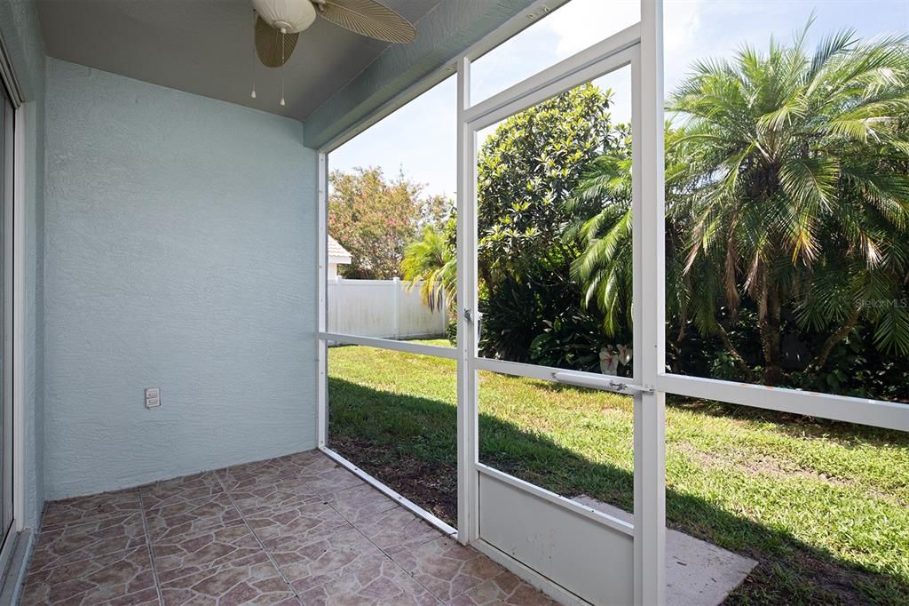 SERENE outdoor living space, this 56 Sq foot screened patio helps to add to the flow of the home. So private, with vinyl fencing and lots of rich foliage.